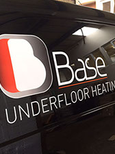 this image shows a black van with a printed graphic logo and text on the rear side. produced and installed by imagine signs.
